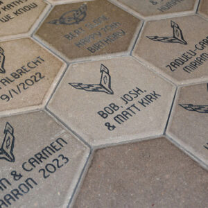 Hexagon Corvette Boulevard bricks engraved with donor names and Corvette generation logos.