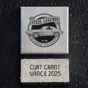 Small and medium NCM Motorsports Park bricks shown together, featuring an engraved name and custom artwork.